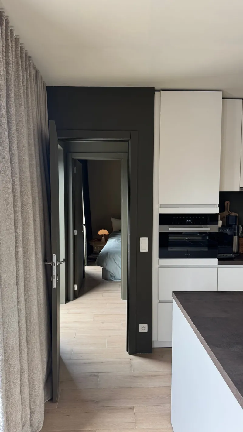 Hallway linking the Miele kitchen to the double bedroom in a Ghent furnished apartment