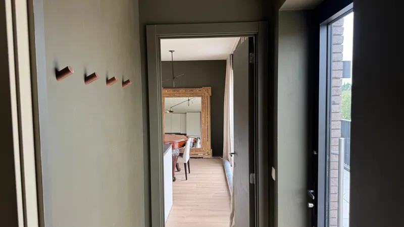 Kitchen with glass doors onto the private 14 m² terrace with a table and chairs
